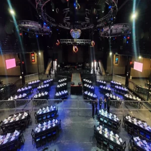 Banquet seating and stage production inside a large Houston event venue