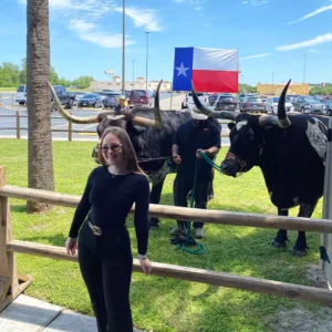 Guest posing with Texas longhorns at Imagen Venues, a turn-key corporate event venue in Houston