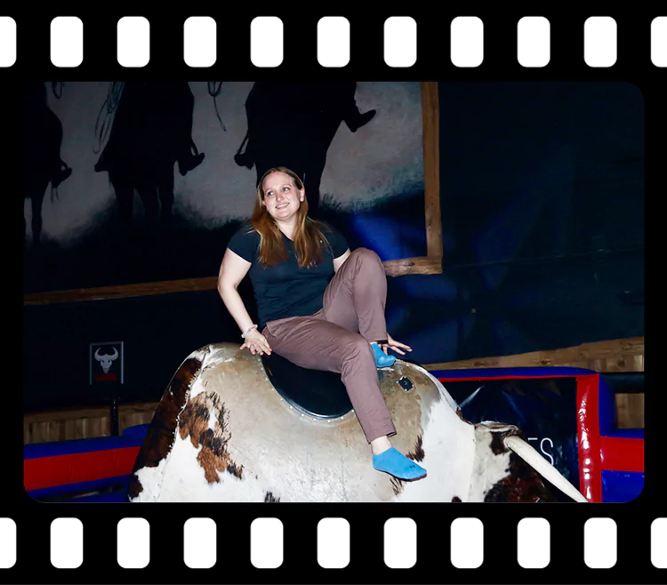 Guest riding mechanical bull with cheering crowd at Imagen Venues Houston