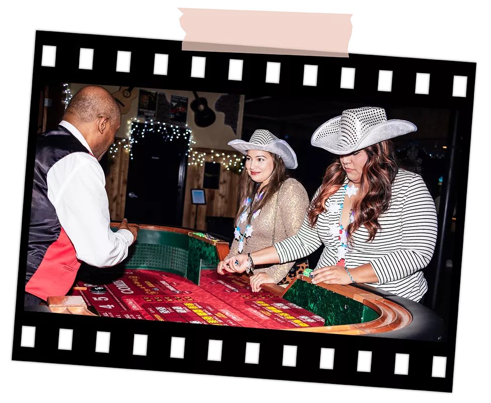 Guests enjoying a casino-themed table game with a dealer during a corporate event at Imagen Venues Houston