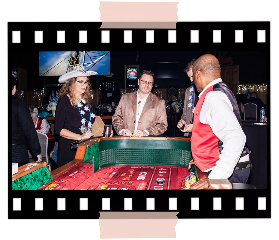 Guests participating in a casino-themed table game during a corporate event at Imagen Venues Houston