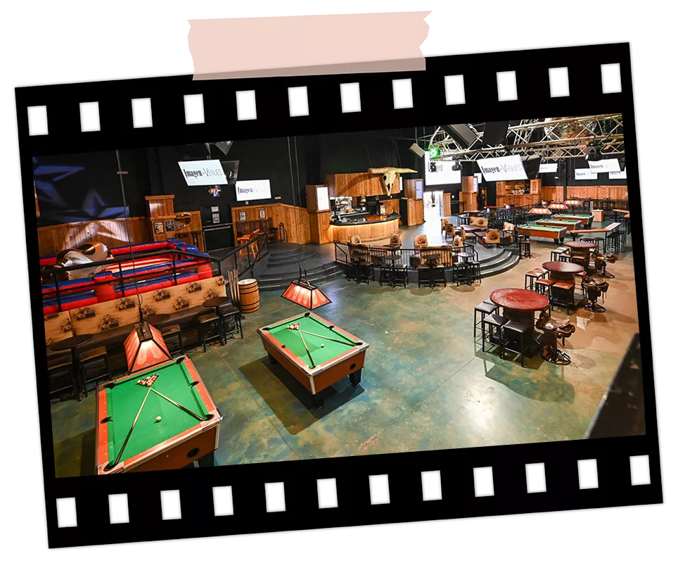 Spacious corporate event lounge with multiple pool tables, seating areas, and built-in entertainment at Imagen Venues in Houston