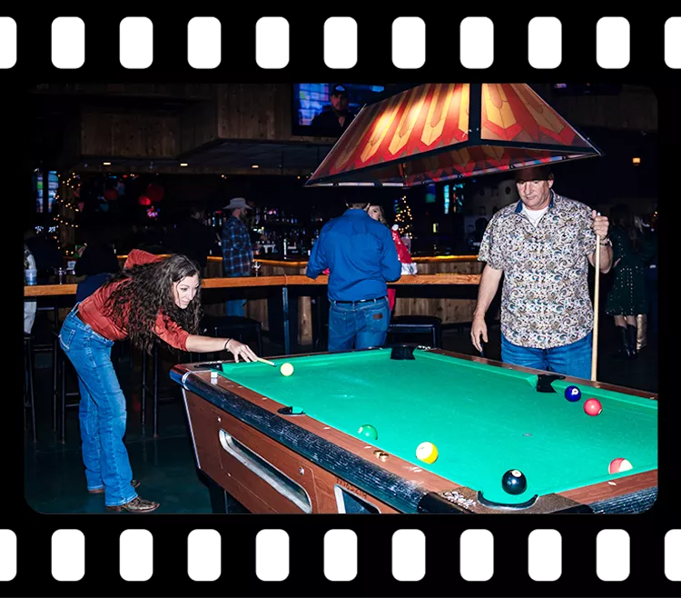 People enjoying a game of pool in a lively entertainment area during a corporate event at Imagen Venues Houston